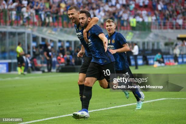 Hakan Calhanoglu of FC Internazionale celebrates with team mates Edin Dzeko and Nicolo Barella after scoring to give the side a 2-0 lead during the...