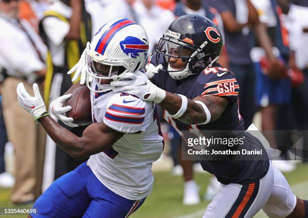 Marqui Christian of the Chicago Bears pulls down Isaiah McKenzie of the Buffalo Bills during a preseason game at Soldier Field on August 21, 2021 in...