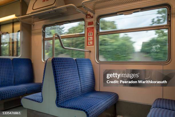 interior view of a corridor inside passenger trains with blue fabric seats of german railway train system. empty vacant passenger car inside the tram. - empty seat photos et images de collection