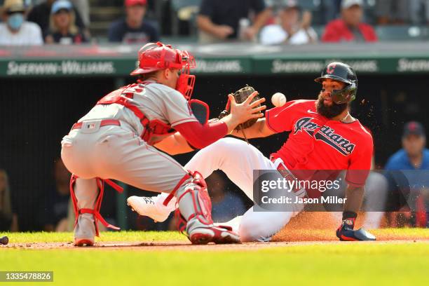 Catcher Max Stassi of the Los Angeles Angels tags out Amed Rosario of the Cleveland Indians at home during the first inning at Progressive Field on...