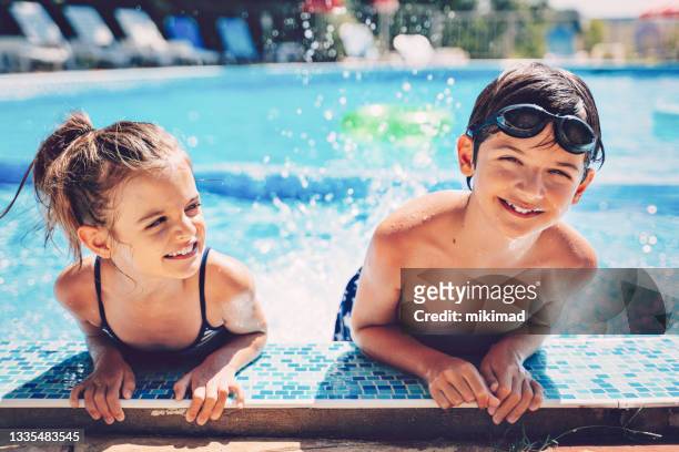 kids playing in swimming pool. children swim. family fun. - kids pool games stock pictures, royalty-free photos & images