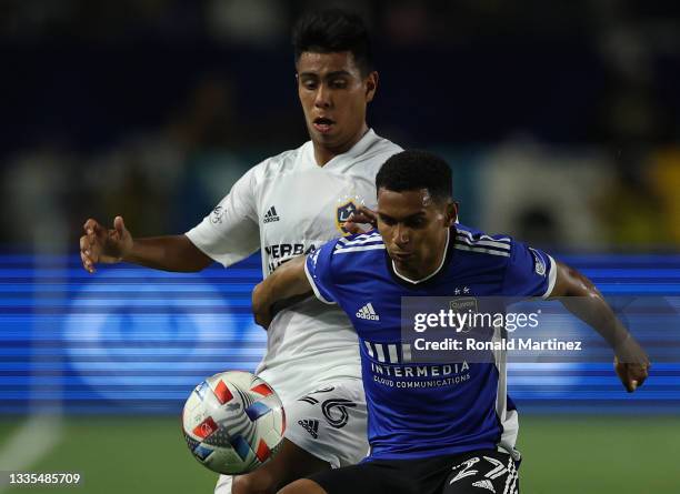 Efrain Alvarez of Los Angeles Galaxy and Marcos Lopez of San Jose Earthquakes in the first half at Dignity Health Sports Park on August 20, 2021 in...