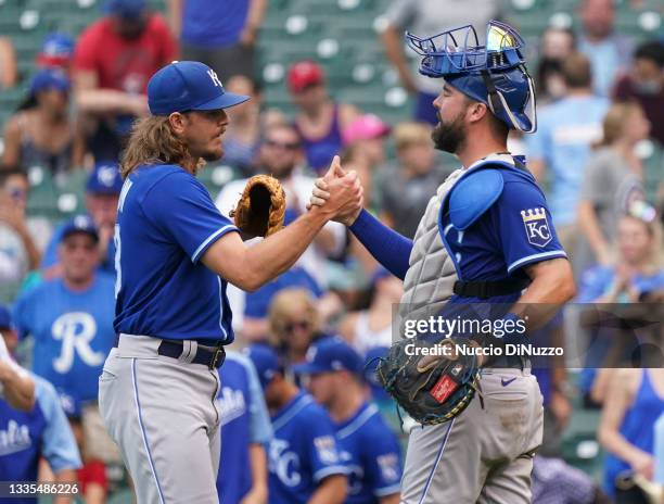 Scott Barlow and Cam Gallagher of the Kansas City Royals celebrate after the last out against the Chicago Cubs at Wrigley Field on August 21, 2021 in...