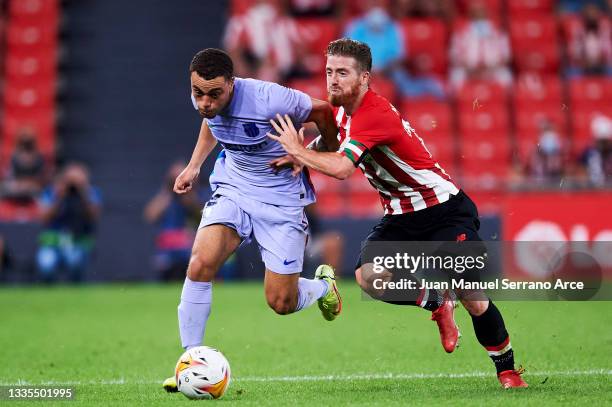 Sergino Dest of FC Barcelona duels for the ball with Iker Muniain of Athletic Club during the LaLiga Santander match between Athletic Club and FC...