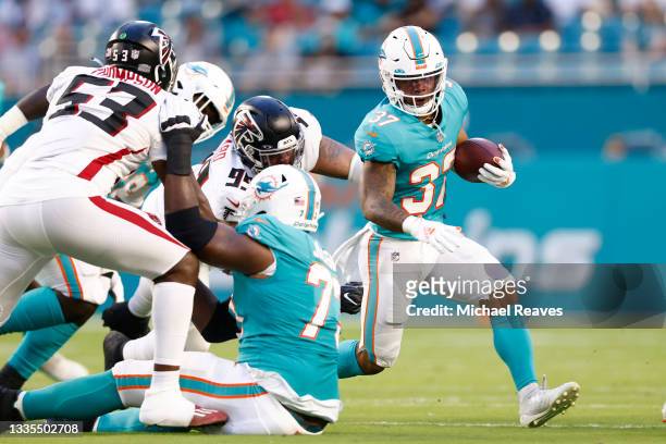 Myles Gaskin of the Miami Dolphins runs with the ball during a preseason game against the Atlanta Falcons at Hard Rock Stadium on August 21, 2021 in...