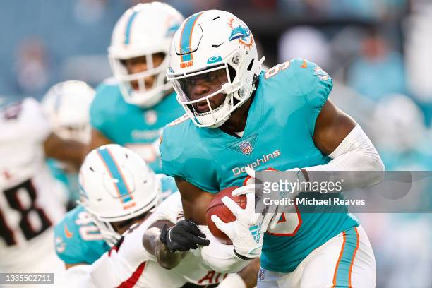 Noah Igbinoghene of the Miami Dolphins returns a kickoff during a preseason game against the Atlanta Falcons at Hard Rock Stadium on August 21, 2021...