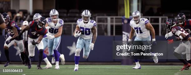 Running back Tony Pollard of the Dallas Cowboys carries the ball against the Houston Texans in the first quarter of a preseason NFL game at AT&T...