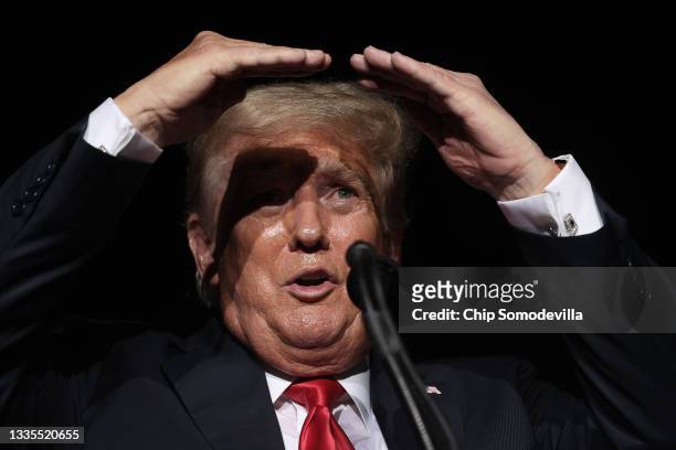 Former U.S. President Donald Trump addresses supporters during a "Save America" rally at York Family Farms on August 21, 2021 in Cullman, Alabama....