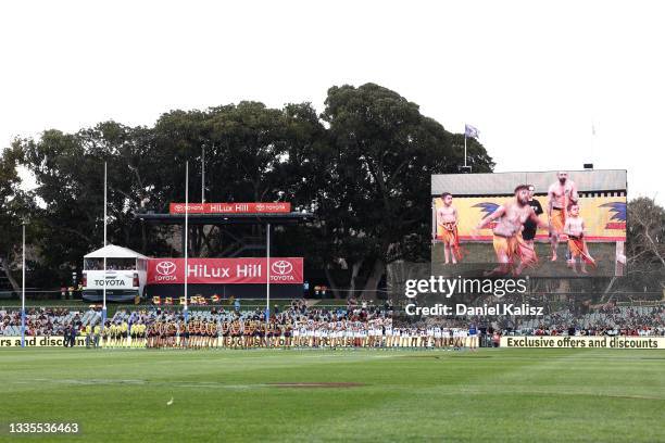 Adelaide Crows and North Melbourne Kangaroos players pause for the welcome to country prior to the round 23 AFL match between Adelaide Crows and...