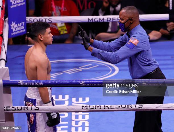 Referee Kenny Bayless gives a count to Julio Ceja after he was knocked down by Mark Magsayo in the first round of their featherweight bout at...