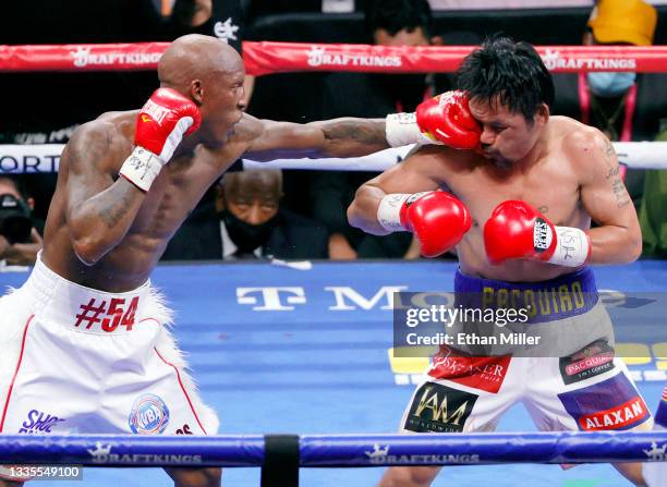 Yordenis Ugas hits Manny Pacquiao in the sixth round of their WBA welterweight title fight at T-Mobile Arena on August 21, 2021 in Las Vegas, Nevada....