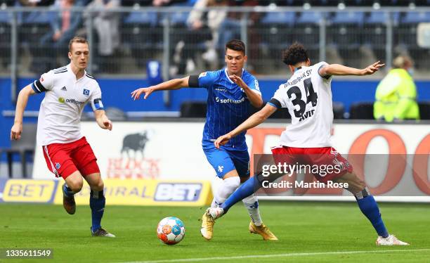 Fabian Schnellhardt of SV Darmstadt 98 looks to break away from Jonas David of Hamburger SV during the Second Bundesliga match between Hamburger SV...