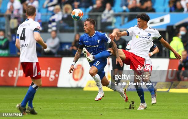 Philip Tietz of SV Darmstadt 98 battles for possession with Jonas David of Hamburger SV during the Second Bundesliga match between Hamburger SV and...