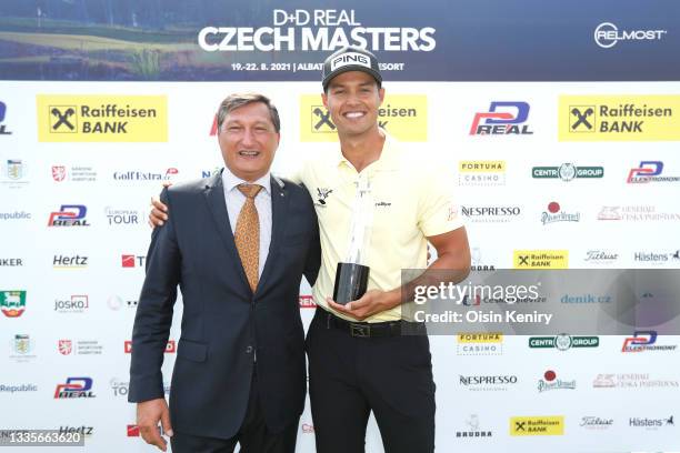 Johannes Veerman of United States poses with the trophy after winning the D+D Real Czech Masters alongside Igor Vida, CEO of Raiffeisen Bank during...