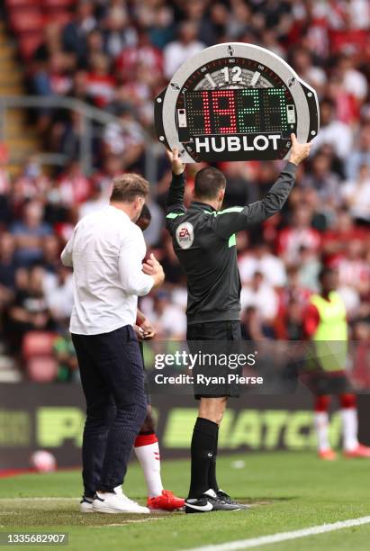 Fourth Official, Jarred Gillett holds aloft the substitutes board during the Premier League match between Southampton and Manchester United at St...