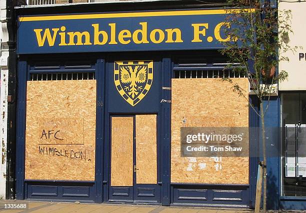 The Wimbledon Football Club shop, boarded up with grafitti from the new AFC Wimbledon club on it on August 14, 2002 in Wimbledon.