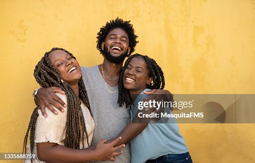 Hugging afro people yellow background Hugging afro people yellow background