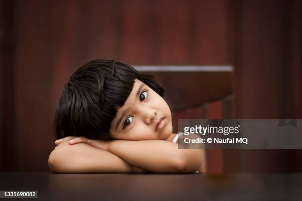 child sitting on a chair - beautiful arabian girls stock pictures, royalty-free photos & images