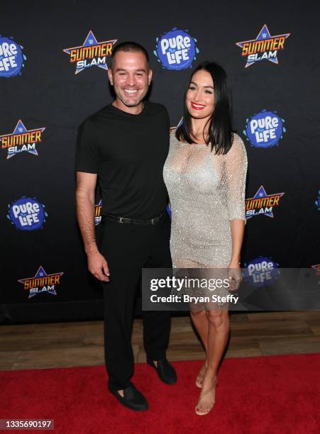 Television personality J.J. Garcia and professional wrestler and television personality Nikki Bella attend the WWE SummerSlam after party at Delano...