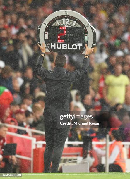 Fourth Official, David Coote holds aloft the substitutes board during the Premier League match between Arsenal and Chelsea at Emirates Stadium on...