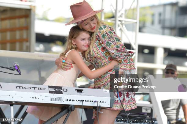 Singer-songwriter, mental health expert Jewel gives Michaela Bryan and hug after her performance during Keen On Presents, Opening Act on the Fitness...