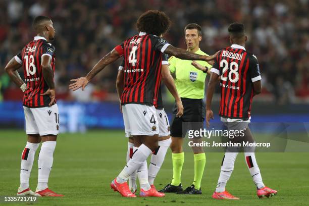 The referee Benoit Bastien calls for calm amongst the OGC Nice players during the Ligue 1 Uber Eats match between Nice and Marseille at Allianz...