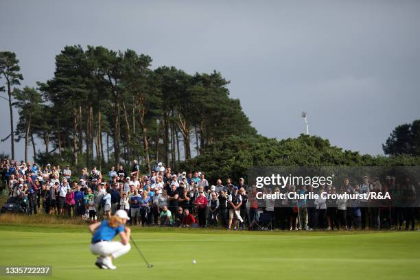 Spectators look on as Louise Duncan of Scotland lines up a putt during Day Four of the AIG Women's Open at Carnoustie Golf Links on August 22, 2021...