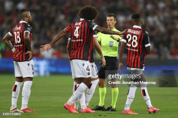 The referee Benoit Bastien calls for calm amongst the OGC Nice players during the Ligue 1 Uber Eats match between Nice and Marseille at Allianz...