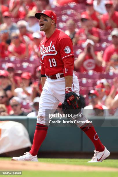 Joey Votto of the Cincinnati Reds reacts after making a play at first base during the first inning in the game against the Miami Marlins at Great...