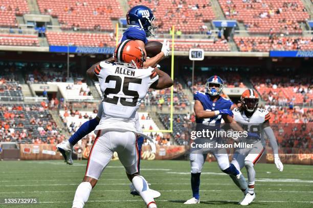 Cornerback Brian Allen of the Cleveland Browns tries to stop wide receiver David Sills of the New York Giants from making a touchdown reception...