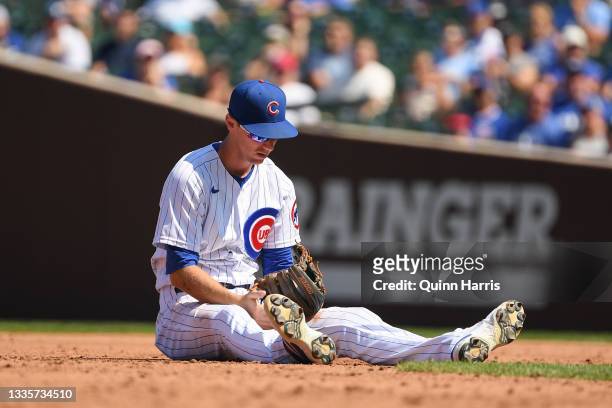 Matt Duffy of the Chicago Cubs reacts after not tagging out Hunter Dozier of the Kansas City Royals in the third inning against the Chicago Cubs at...
