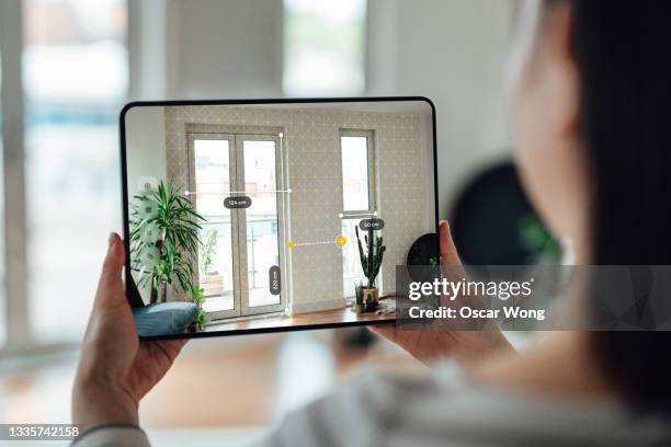 using augmented reality technology to measure dimensions - holding digital tablet stock pictures, royalty-free photos & images