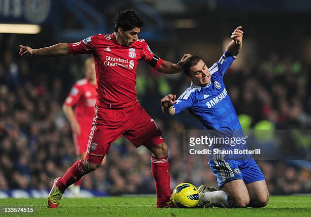 Luis Suarez of Liverpool challenges Branislav Ivanovic of Chelsea during the Barclays Premier League match between Chelsea and Liverpool at Stamford...