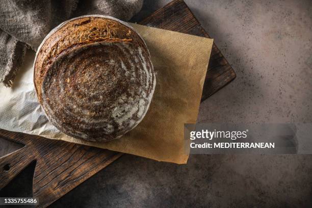 sourdough bread brown loaf homemade german style on cutting board - rye bread stock pictures, royalty-free photos & images