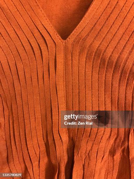 front of orange brown solid color dress with pleats and v-shape neckline - brun blus bildbanksfoton och bilder