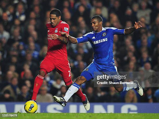 Glen Johnson of Liverpool goes past Florent Malouda of Chelsea on his way to scoring during the Barclays Premier League match between Chelsea and...