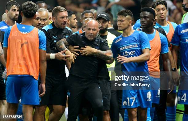 Incidents between the players of Marseille and the supporters of Nice who entered the pitch - here coach of OM Jorge Sampaoli being pushed back by...