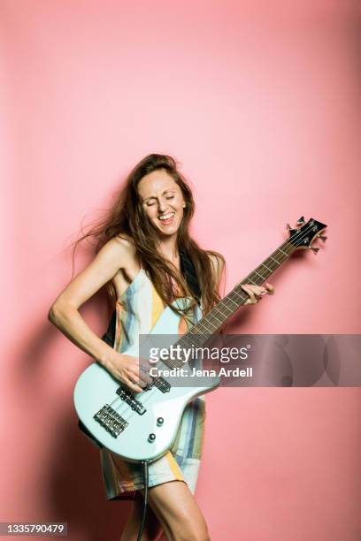 female musician, cool woman portrait of woman playing guitar in rock band - women pastel stock pictures, royalty-free photos & images