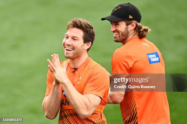 Toby Greene and Callan Ward share a joke during a GWS Giants AFL training session at North Port Oval on August 23, 2021 in Melbourne, Australia.