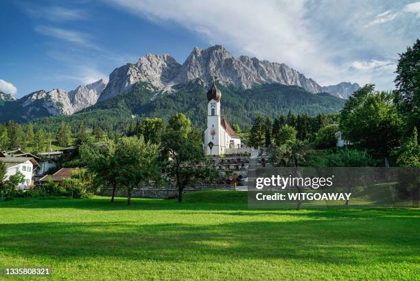 garmisch-partenkirchen, germany  - august 11, 2018: the parish church of st. john the baptist - garmisch partenkirchen stock pictures, royalty-free photos & images