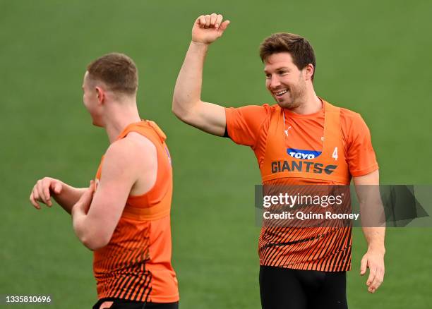 Toby Greene of the Giants has a laugh with team mates during a GWS Giants AFL training session at North Port Oval on August 23, 2021 in Melbourne,...