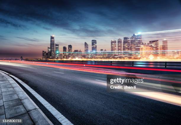 expressway along the urban coastline at night - long exposure night sky stock pictures, royalty-free photos & images