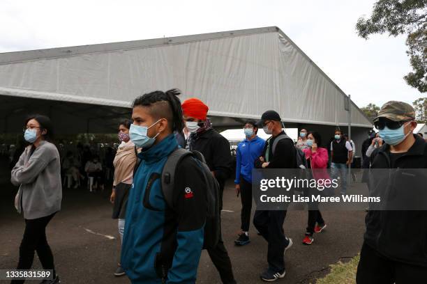 People arrive to be vaccinated at the New South Wales Health mass vaccination hub in Homebush on August 23, 2021 in Sydney, Australia. Further...