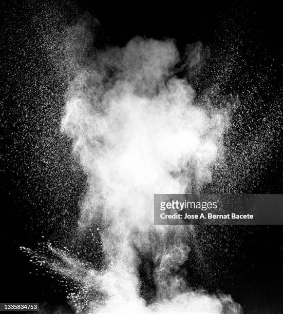 rising explosion of smoke and white powder on a black surface. - creative destruction stock pictures, royalty-free photos & images