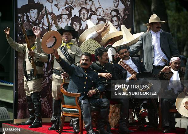 Men representing Mexican revolutionary leaders Francisco Villa and Emiliano Zapata perform during a military parade commemorating the 101th...