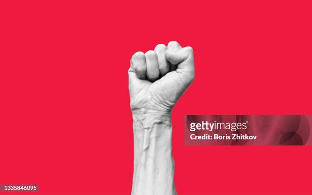 raised fist. - red revolution stock pictures, royalty-free photos & images