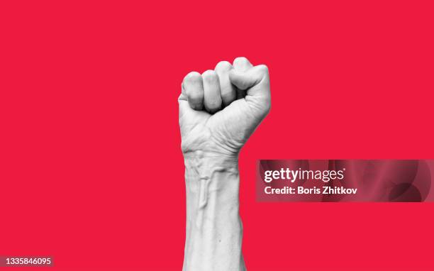 raised fist. - unconventional imagens e fotografias de stock