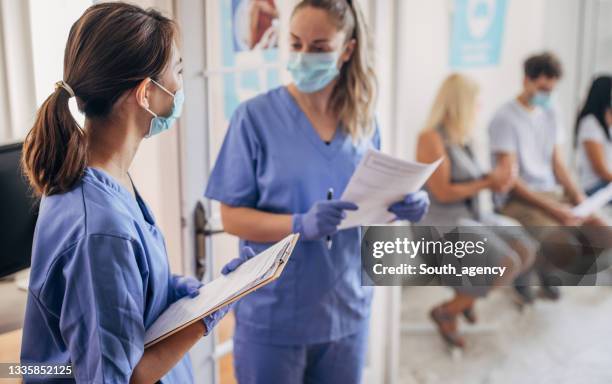 busy day at vaccination center - five people with masks stock pictures, royalty-free photos & images
