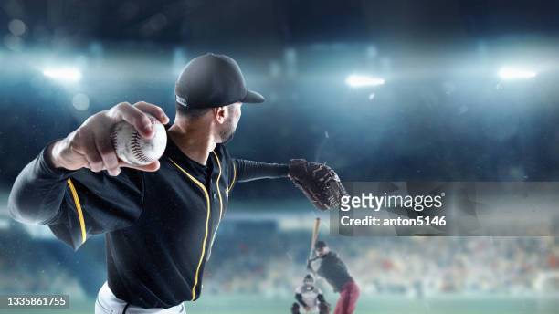 professional baseball player in motion, action during match at stadium over blue evening sky with spotlights. concept of sport, show, competition. - bola de basebol imagens e fotografias de stock