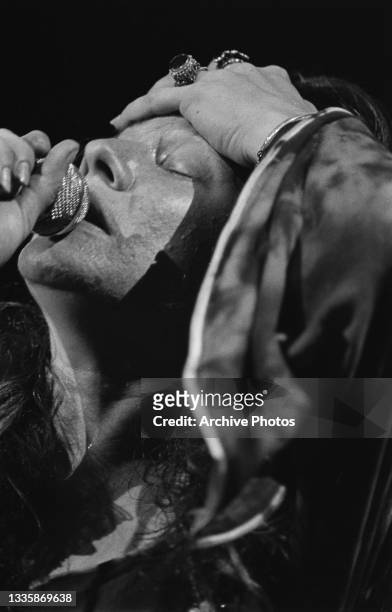 American singer-songwriter Janis Joplin , with her hand on her forehead, performs live at the Woodstock festival, at Max Yasgur's dairy farm in...